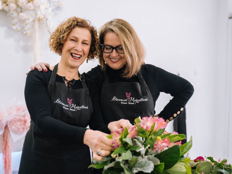women smiling at flower arranging workshop
